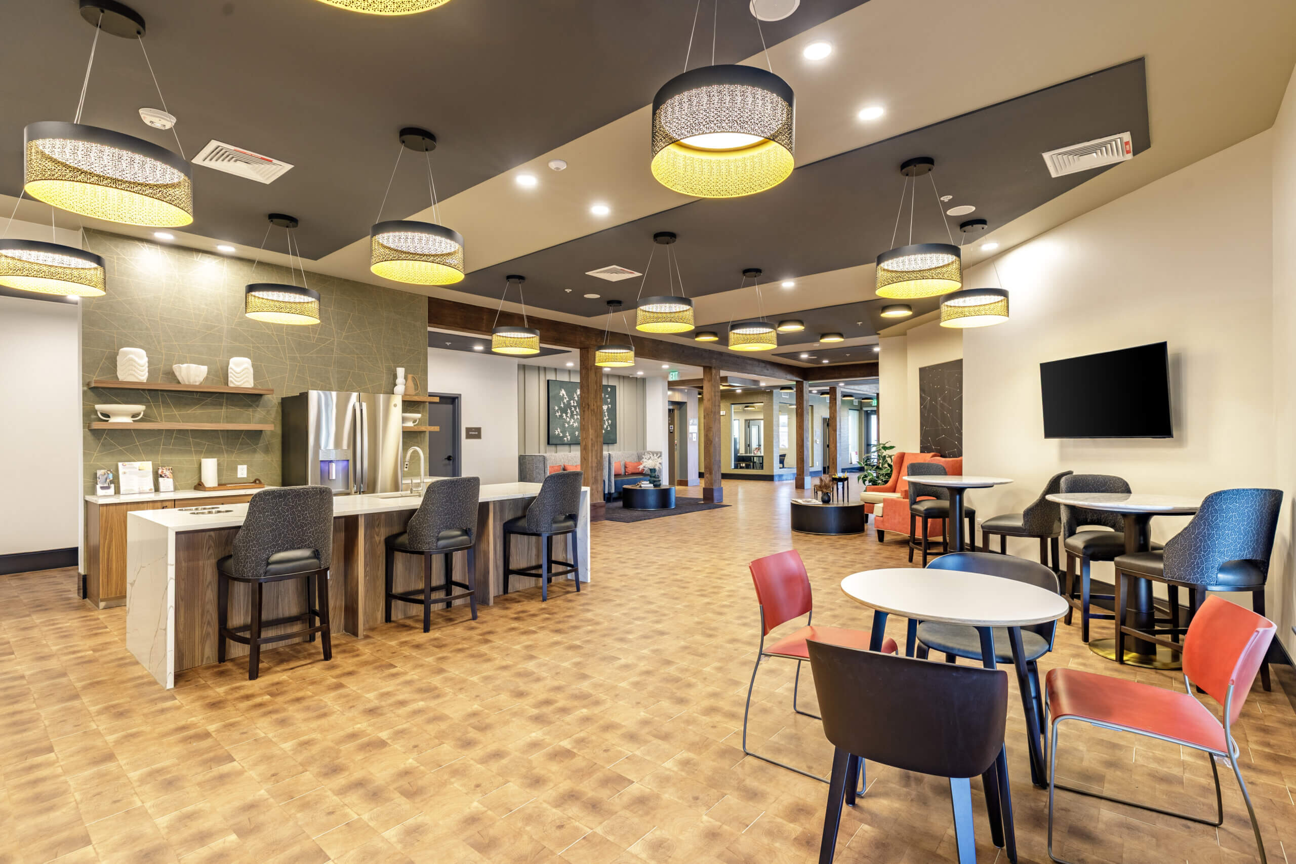 Modern seating area with tables and ceiling lights