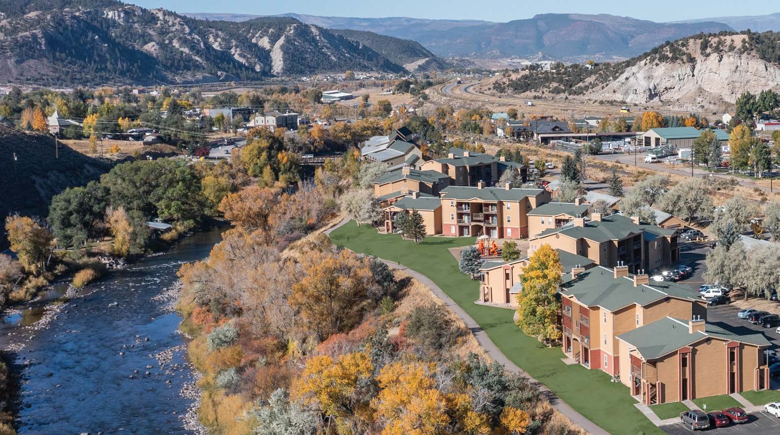 Aerial view of Eagle Villas near a river.