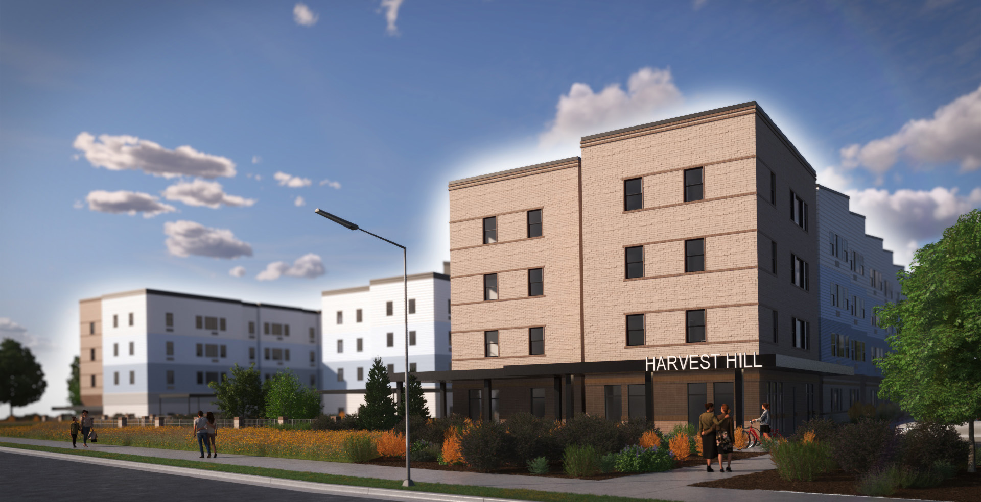 Harvest Hill apartments under a blue sky with scattered clouds, featuring people walking and biking in the foreground