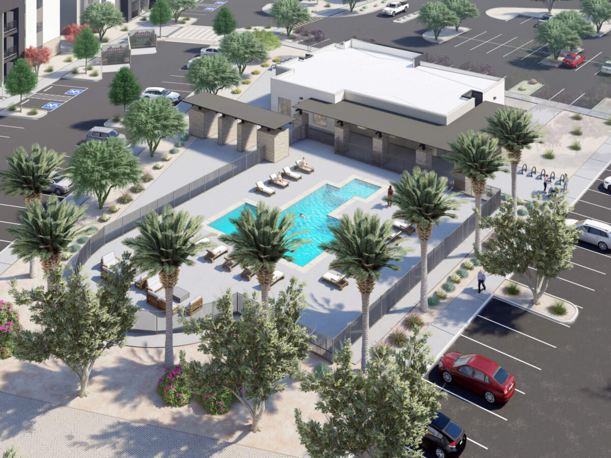 Aerial view of a pool and surrounding parking area.