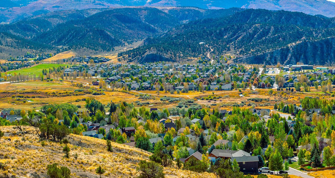 Aerial view of a town surrounded by mountains.