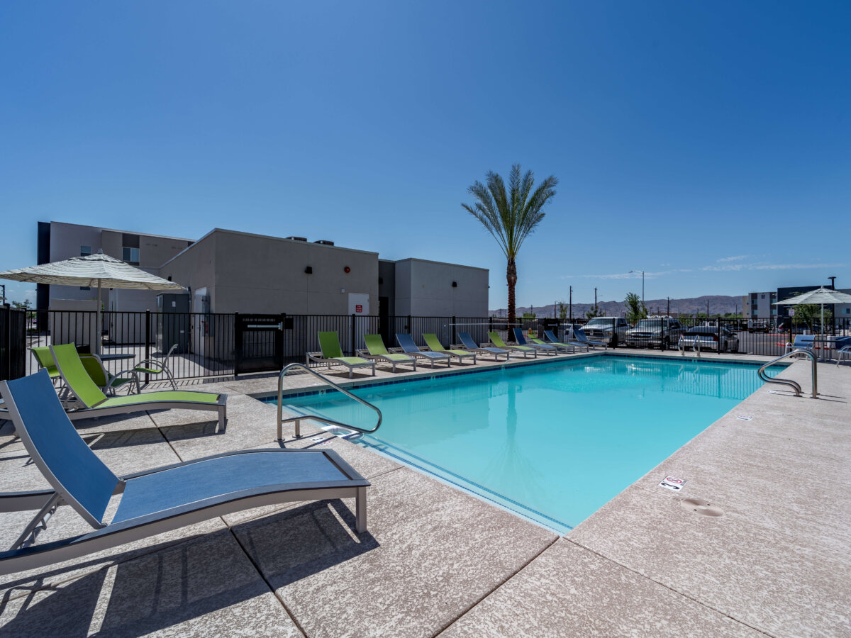 Swimming pool with lounge chairs and umbrellas.