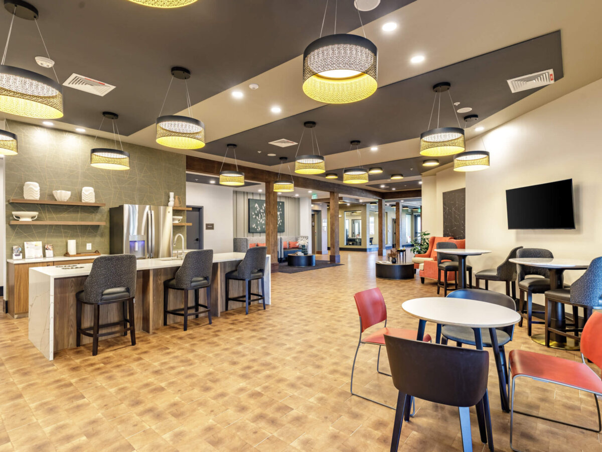 Modern seating area with tables and ceiling lights